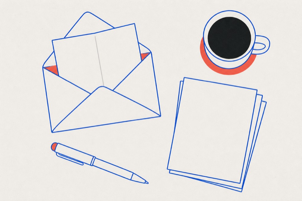 Overhead view of a desk with an open envelope, a letter, a pen, papers and a mug